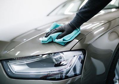 A man cleaning car with microfiber cloth, car detailing (or vale